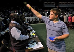 A newly confirmed youth sprinkles water on delegates as they reaffirm their baptismal vows during the 2008 General Conference in Fort Worth, Texas.