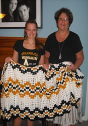 Karen Marlow (right) knitted the large prayer shawl that Catherine Allen received a few weeks after enrolling at Appalachian State University. The shawl features Allenâ€™s school colors. Both are members of Bon Air United Methodist Church.