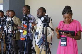 Congolese communicators learn to shoot with their DSLR cameras and to send the images via wi-fi to their iPads.  Checking her iPad is Irene Kashala Tsheleka.  Photo by Kathleen Barry, UMNS.