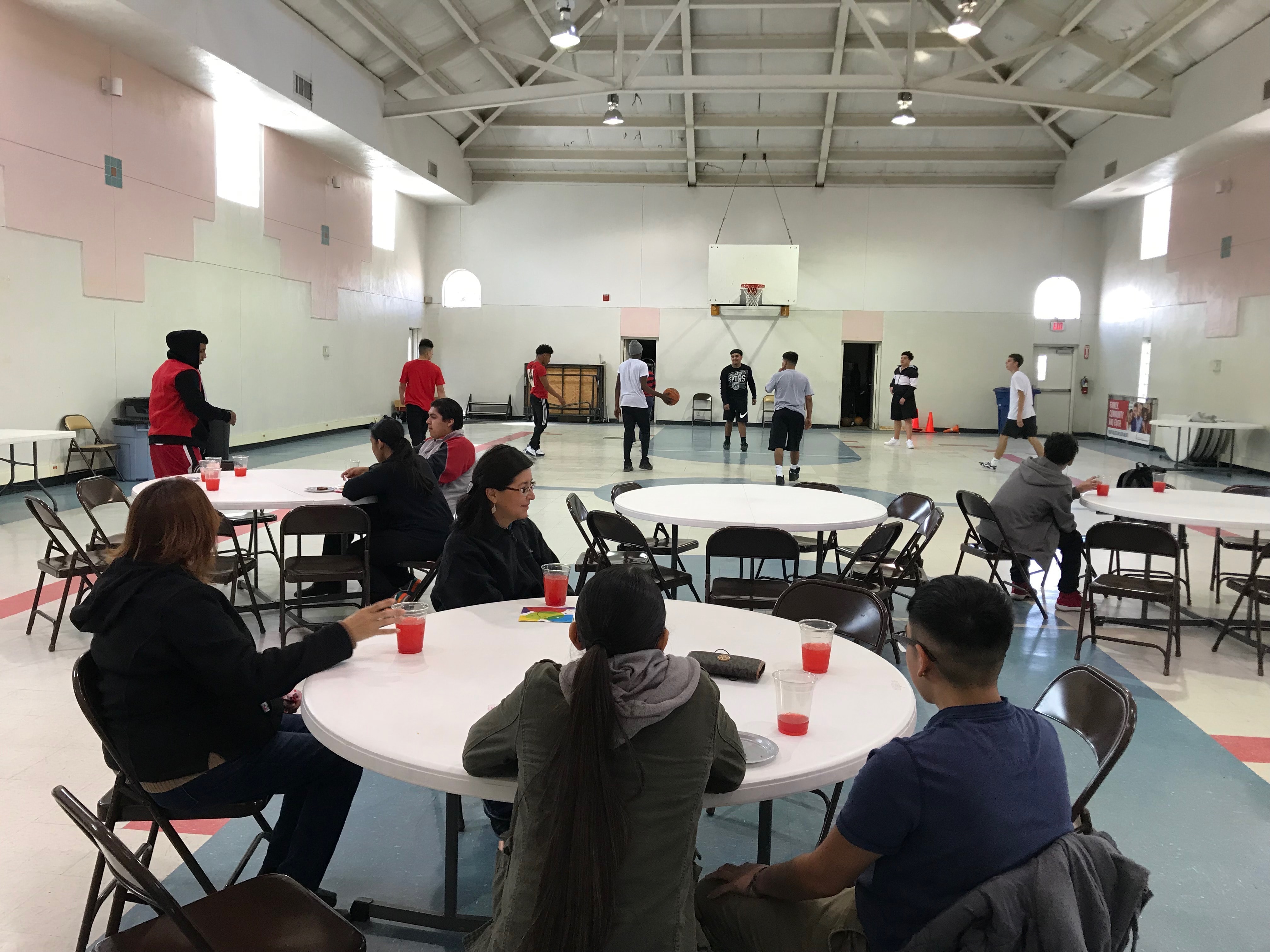 Cooper Academy students eating lunch and playing basketball in La Trinidad's gym. Courtesy of La Trinidad.