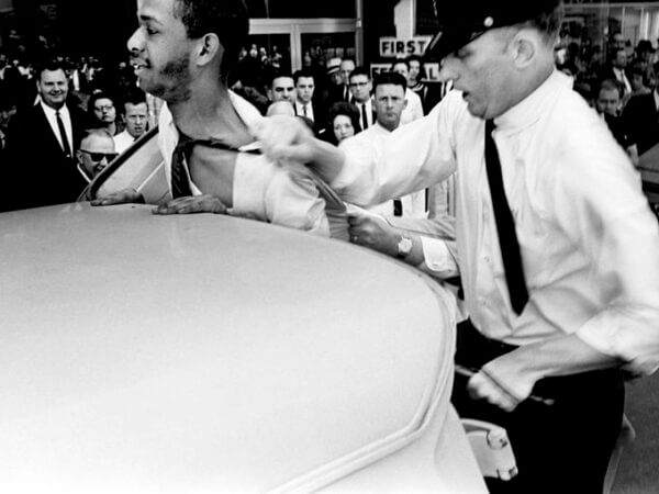 Photo: Metro police officers wrestle with demonstrator William Barbee, left, a student at Scarritt College, as they attempt to put him into the paddy wagon after his arrest on Church Street. April 28, 1964. Photo by Frank Empson. Courtesy of The Tennessean.